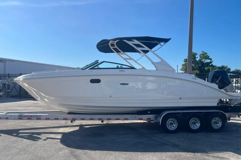 The Image of 2024 Sea Ray SDX 270 Outboard boat on trailer, side view, sunny day. - 0
