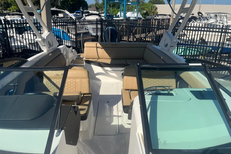 Slide: The Image of 2024 Sea Ray SDX 270 Outboard boat interior with tan seating and windshield. - 6