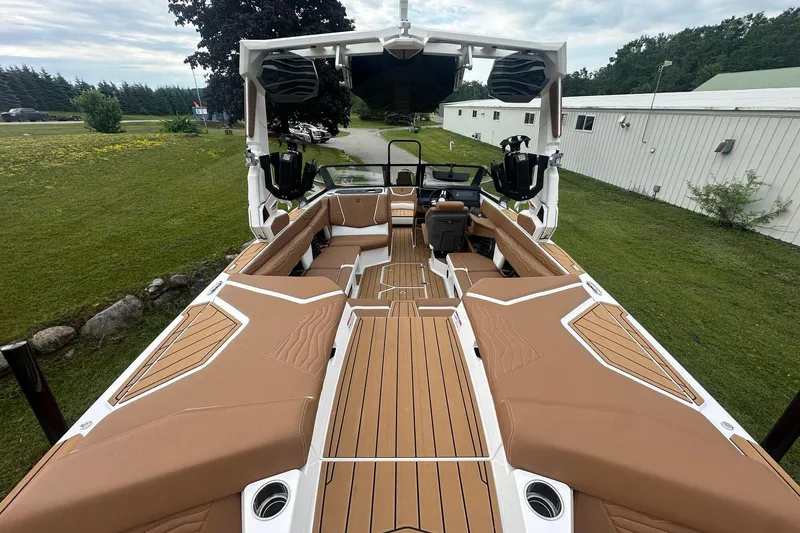 Slide: The Image of 2025 Nautique G23 boat interior with tan seating and sleek design. - 11