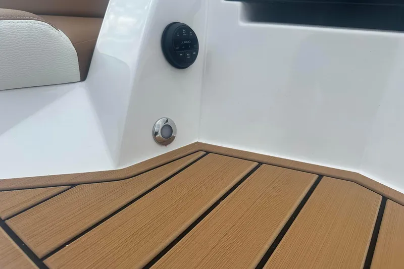 Slide: The Image of 2025 Nautique G23 boat interior with teak flooring and control panel. - 12
