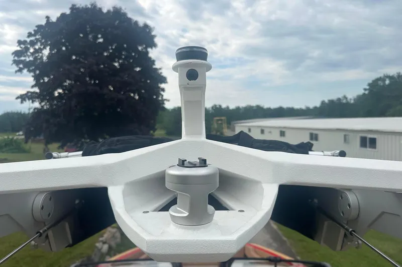 Slide: The Image of 2025 Nautique G23 boat tower against a cloudy sky and tree background. - 15