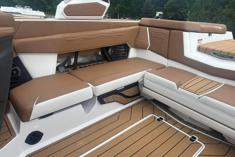 Slide: The Image of 2025 Nautique G23 boat interior with brown and white seating, featuring modern design and detailing. - 18