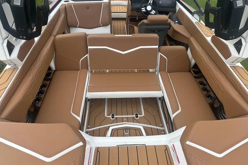 Slide: The Image of 2025 Nautique G23 boat interior with tan leather seating and modern design. - 25