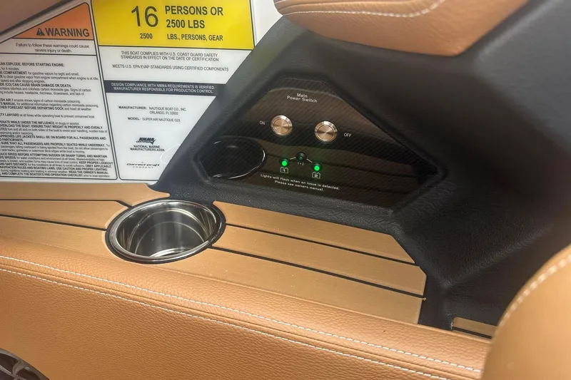Slide: The Image of 2025 Nautique G23 boat interior with warning label and power switch panel. - 30