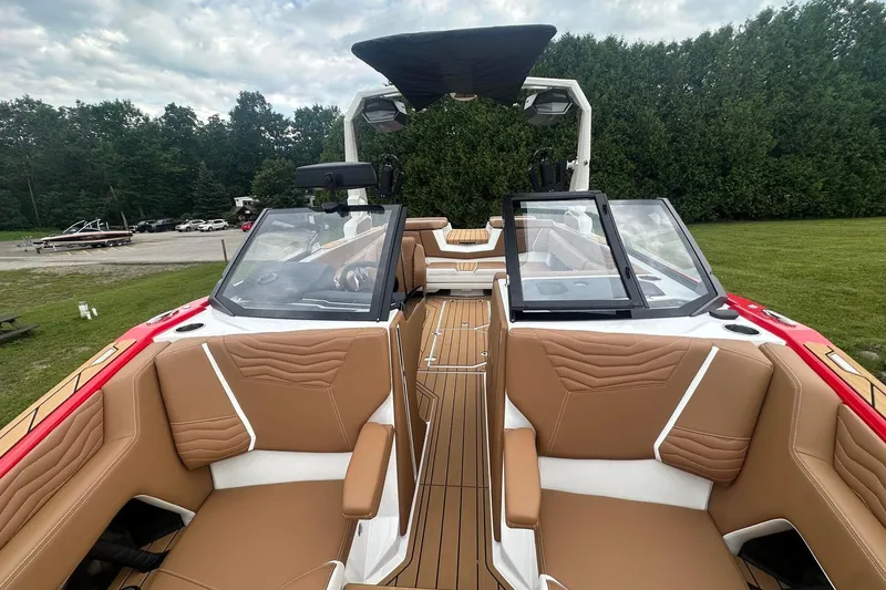 Slide: The Image of 2025 Nautique G23 boat interior with tan seating and sleek design. - 39