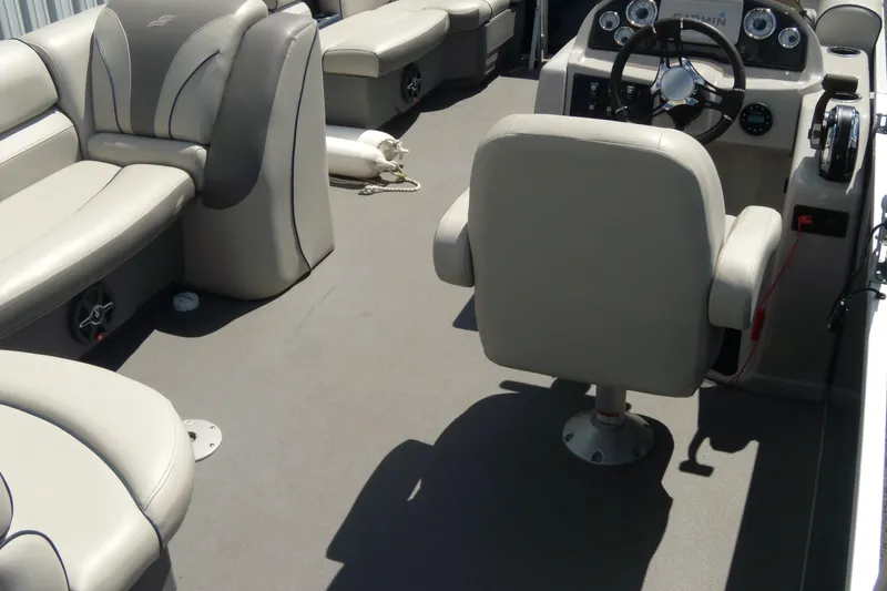 Slide: The Image of 2020 Starcraft EX 20 C boat interior with beige seating and steering console. - 14