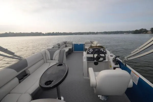 Slide: The Image of Manufacturer Provided Image: 2020 Starcraft EX 20 C pontoon boat interior on a calm lake. - 21