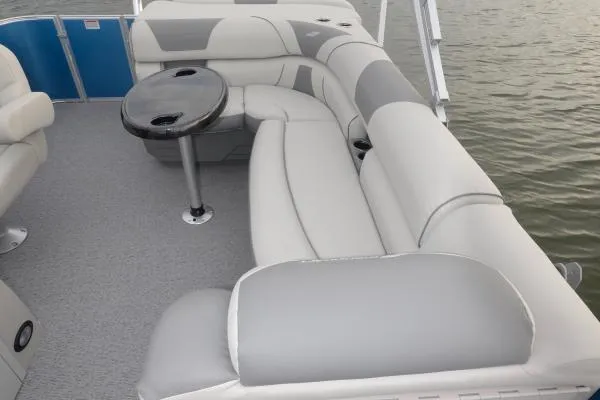 Slide: The Image of Manufacturer Provided Image: 2020 Starcraft EX 20 C pontoon boat interior with gray and white seating and a round table. - 22