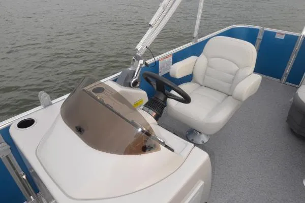 Slide: The Image of Manufacturer Provided Image: 2020 Starcraft EX 20 C boat helm with white captain's chair and steering wheel. - 23