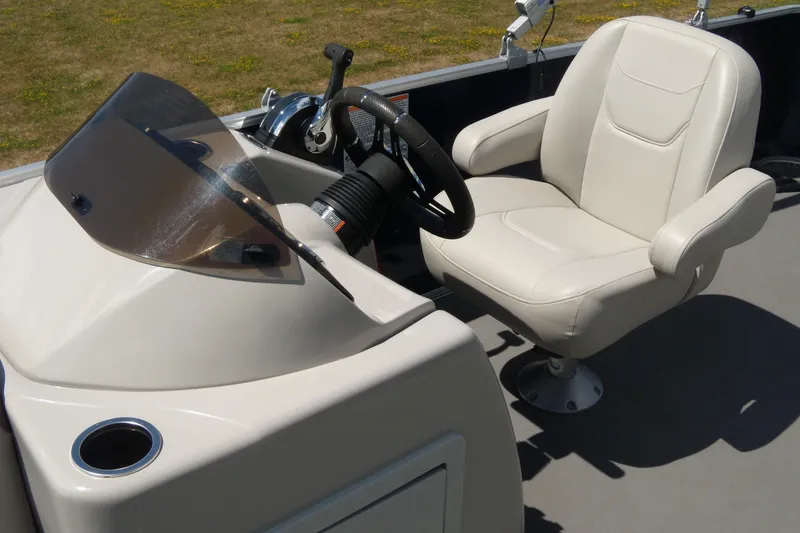 Slide: The Image of 2020 Starcraft EX 20 C boat interior with steering wheel and captain's chair. - 6