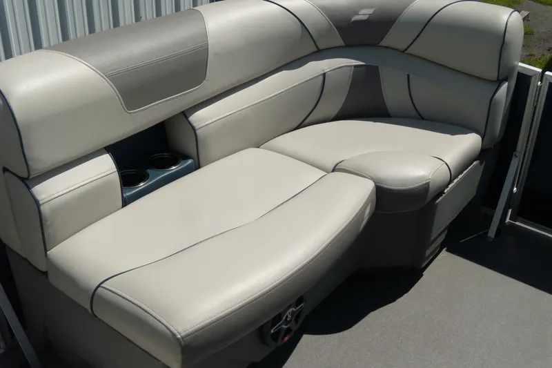 Slide: The Image of 2020 Starcraft EX 20 C boat interior with gray cushioned seating and cup holders. - 8