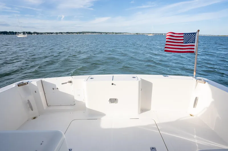 Slide: The Image of 2005 Silverton 34 Convertible boat deck with American flag on open water. - 14