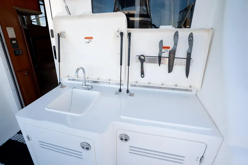 Slide: The Image of 2005 Silverton 34 Convertible yacht kitchen area with sink and knife holder. - 16