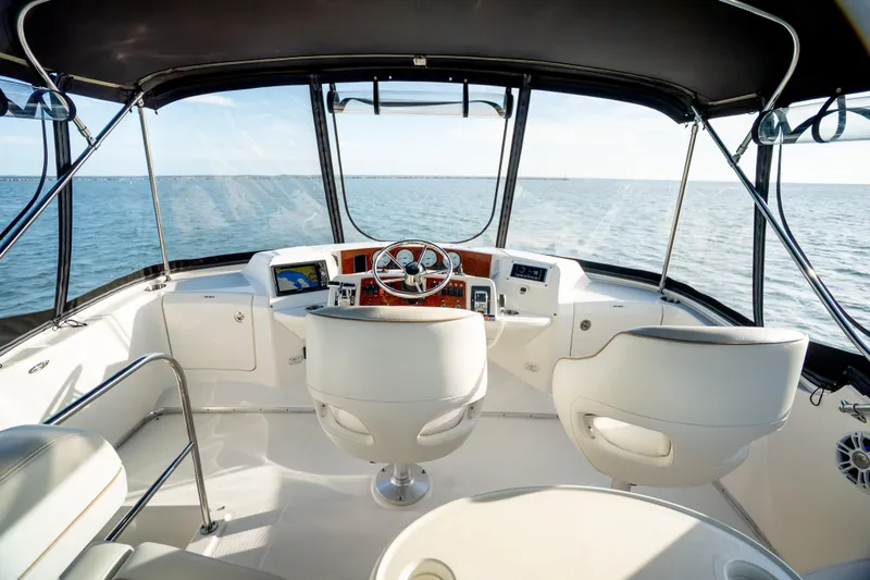 Slide: The Image of 2005 Silverton 34 Convertible yacht cockpit with ocean view, featuring modern navigation equipment. - 17