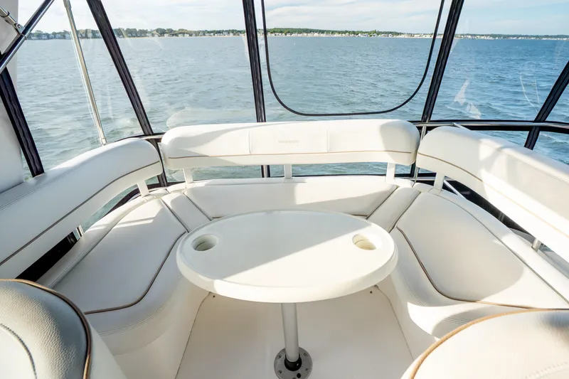 Slide: The Image of Interior view of 2005 Silverton 34 Convertible yacht with white seating and table. - 20