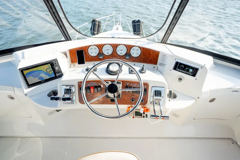 Slide: The Image of Helm of 2005 Silverton 34 Convertible yacht with navigation equipment and steering wheel. - 21