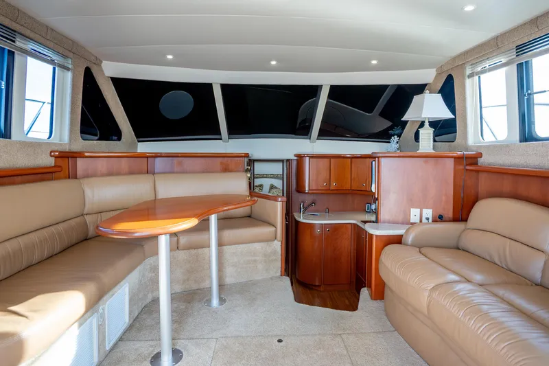 Slide: The Image of Luxurious interior of 2005 Silverton 34 Convertible yacht with leather seating and wooden cabinetry. - 24
