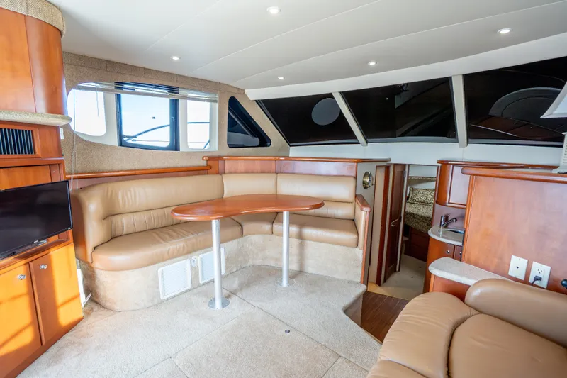 Slide: The Image of Interior of 2005 Silverton 34 Convertible yacht with leather seating and wooden finishes. - 25