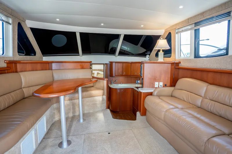 Slide: The Image of Luxurious interior of 2005 Silverton 34 Convertible yacht with leather seating and wooden accents. - 26
