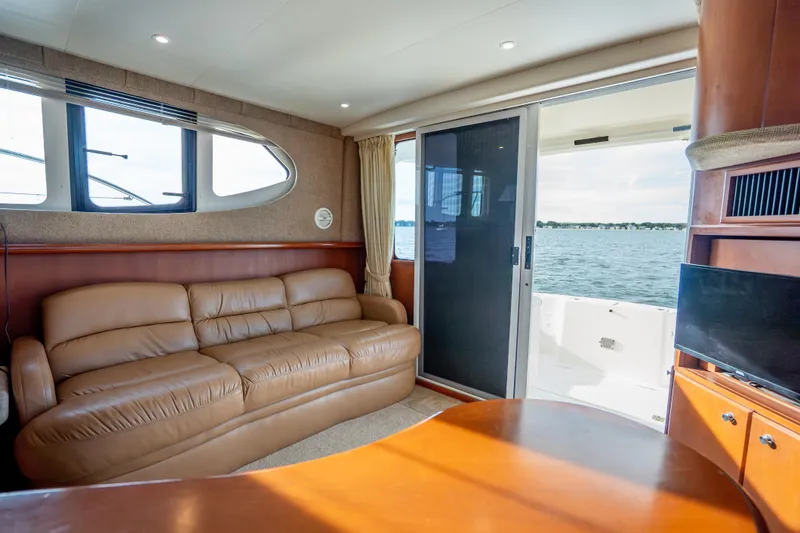 Slide: The Image of Interior of 2005 Silverton 34 Convertible yacht with leather sofa and ocean view. - 28