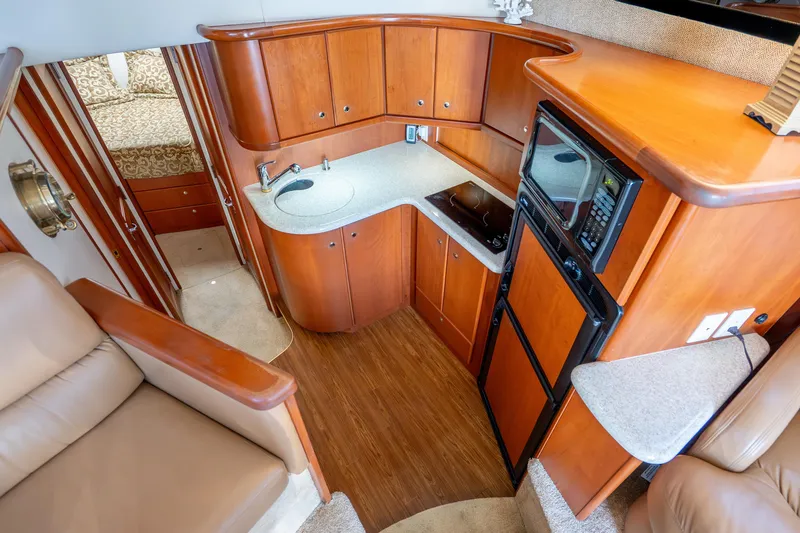 Slide: The Image of Interior of 2005 Silverton 34 Convertible yacht with kitchen and seating area. - 29