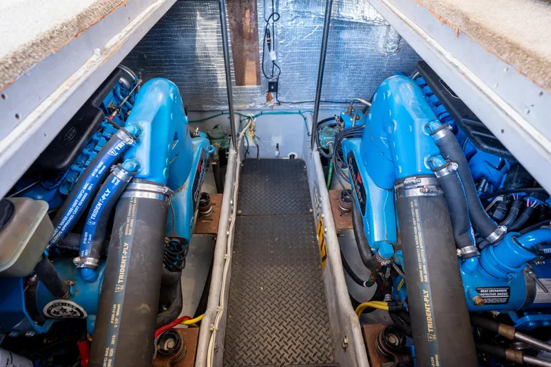 Slide: The Image of Engine room of 2005 Silverton 34 Convertible boat with twin blue engines. - 38