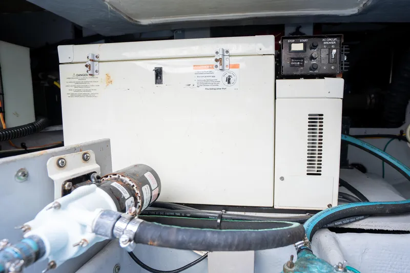 Slide: The Image of Engine compartment of 2005 Silverton 34 Convertible with generator and hoses visible. - 41