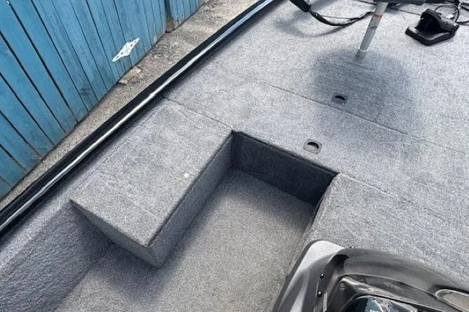 Slide: The Image of 2025 Tracker Pro 170 boat interior with gray carpet and seating area. - 12