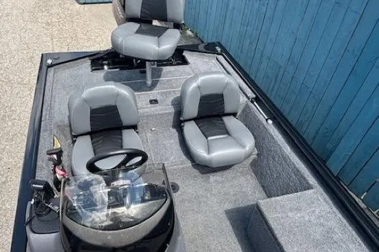 Slide: The Image of 2025 Tracker Pro 170 boat interior with gray seating and steering console. - 16