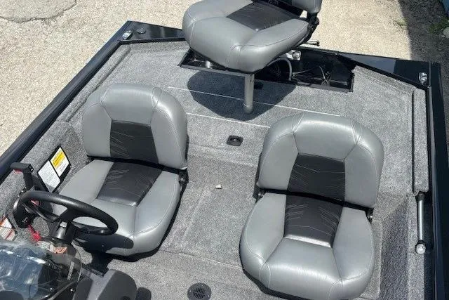 Slide: The Image of 2025 Tracker Pro 170 boat interior with three gray seats and steering wheel. - 17