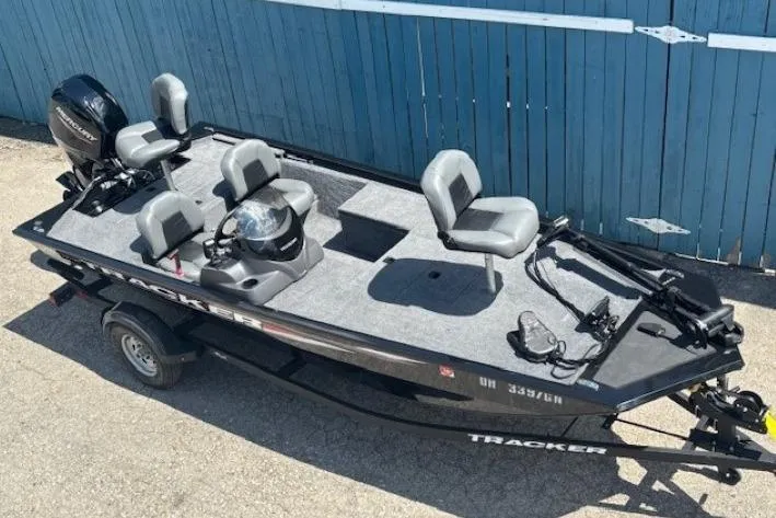 Slide: The Image of 2025 Tracker Pro 170 fishing boat with seating and motor, parked on a trailer. - 5