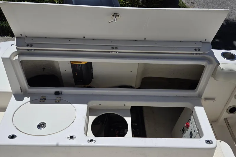 Slide: The Image of 2017 Robalo R222 Center Console boat storage compartments and control panel. - 10