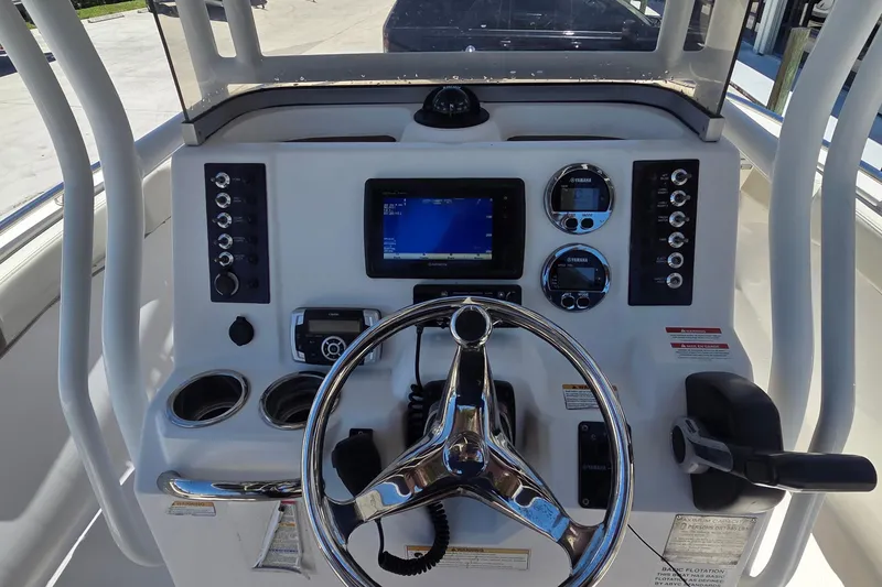 Slide: The Image of 2017 Robalo R222 Center Console dashboard with steering wheel and navigation controls. - 12
