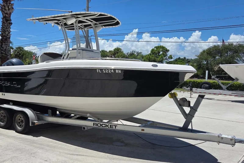 Slide: The Image of 2017 Robalo R222 Center Console boat on trailer under clear blue sky. - 3
