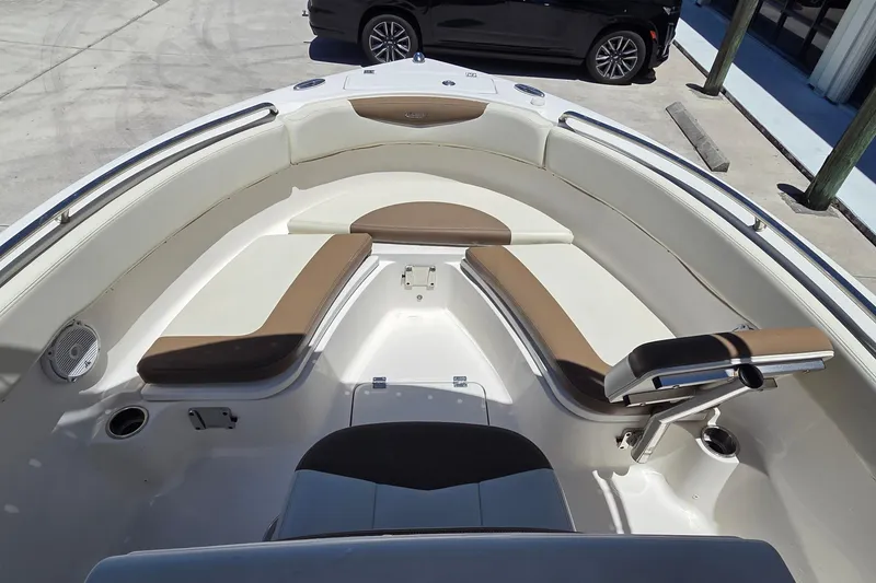 Slide: The Image of 2017 Robalo R222 Center Console boat interior with cushioned seating and storage compartments. - 5
