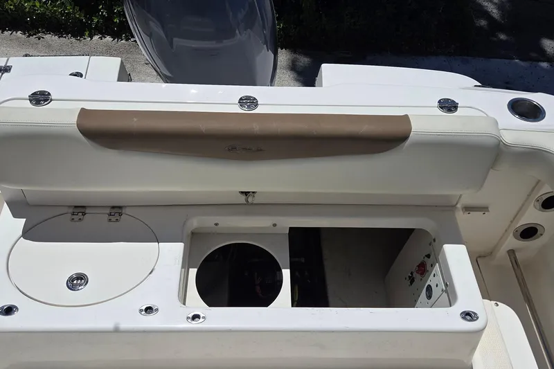 Slide: The Image of 2017 Robalo R222 Center Console boat interior with storage compartments and seating. - 9