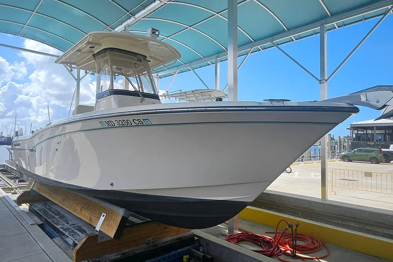 Slide: The Image of 2017 Grady-White Fisherman 257 boat under a blue canopy at a marina. - 13