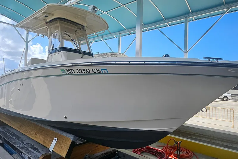 Slide: The Image of 2017 Grady-White Fisherman 257 boat under a blue canopy, docked and ready. - 14
