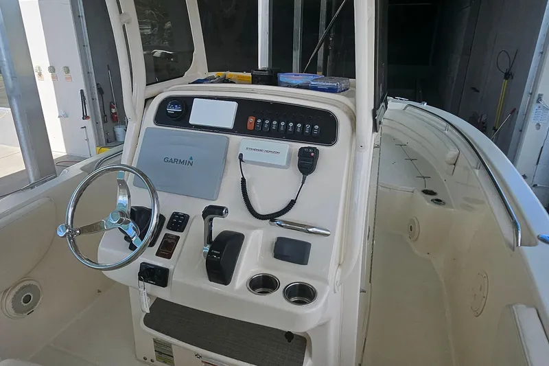 Slide: The Image of 2017 Grady-White Fisherman 257 boat console with Garmin navigation and steering wheel. - 17