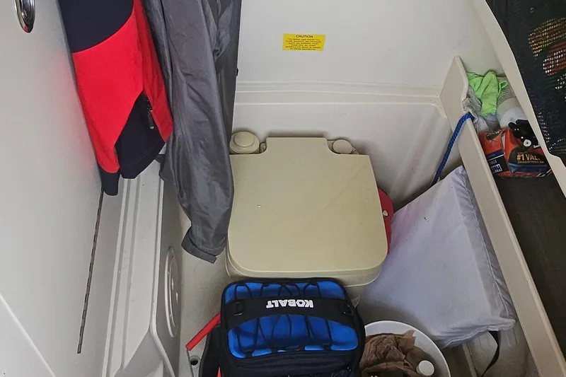 Slide: The Image of Interior of a 2017 Grady-White Fisherman 257 boat with storage and portable toilet. - 18