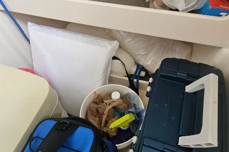 Slide: The Image of Storage area on a 2017 Grady-White Fisherman 257 boat with various items. - 21