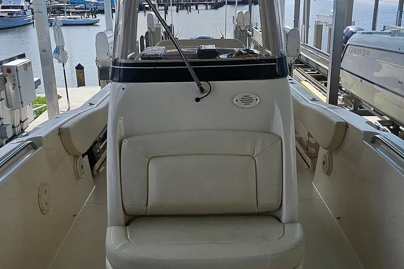 Slide: The Image of 2017 Grady-White Fisherman 257 boat interior at marina, showcasing seating and helm area. - 26