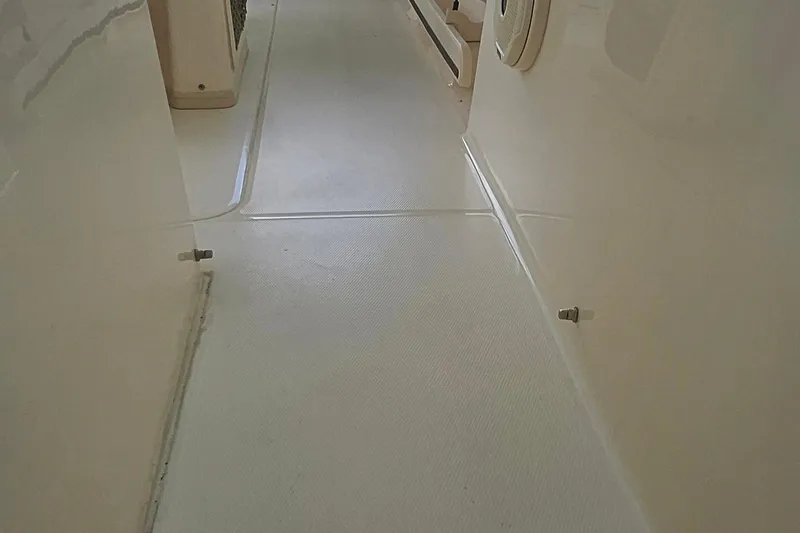 Slide: The Image of 2017 Grady-White Fisherman 257 interior deck view, showcasing clean, textured flooring. - 27