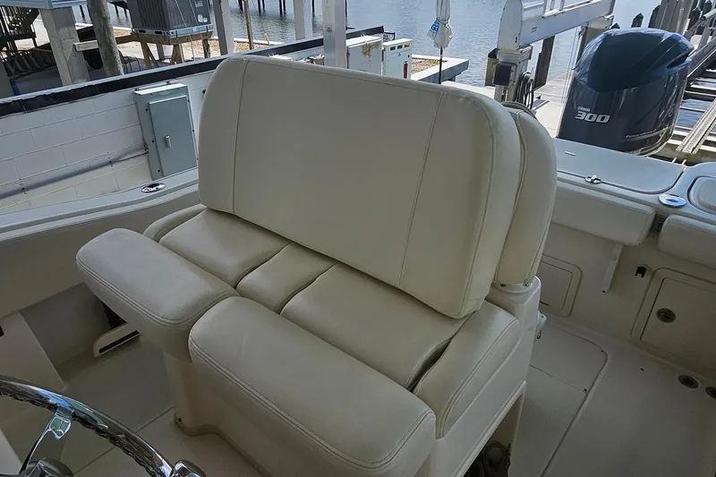 Slide: The Image of 2017 Grady-White Fisherman 257 boat interior with beige seating and Yamaha 300 engine. - 30