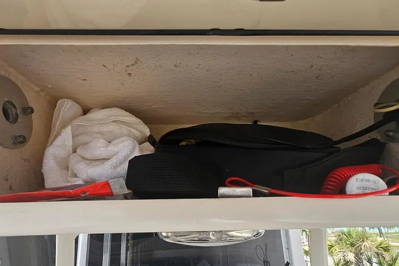 Slide: The Image of Storage compartment on a 2017 Grady-White Fisherman 257 boat with towel and accessories. - 34