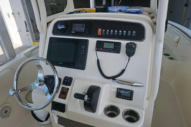 Slide: The Image of 2017 Grady-White Fisherman 257 boat console with steering wheel and navigation controls. - 36