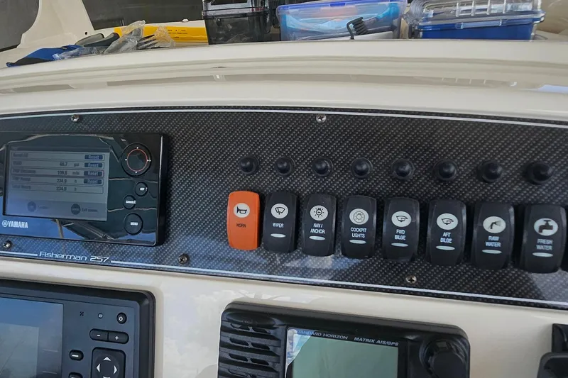 Slide: The Image of 2017 Grady-White Fisherman 257 dashboard with Yamaha controls and various switches. - 40