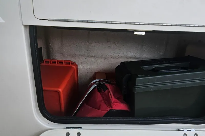 Slide: The Image of Storage compartment of 2017 Grady-White Fisherman 257 with gear and equipment. - 42