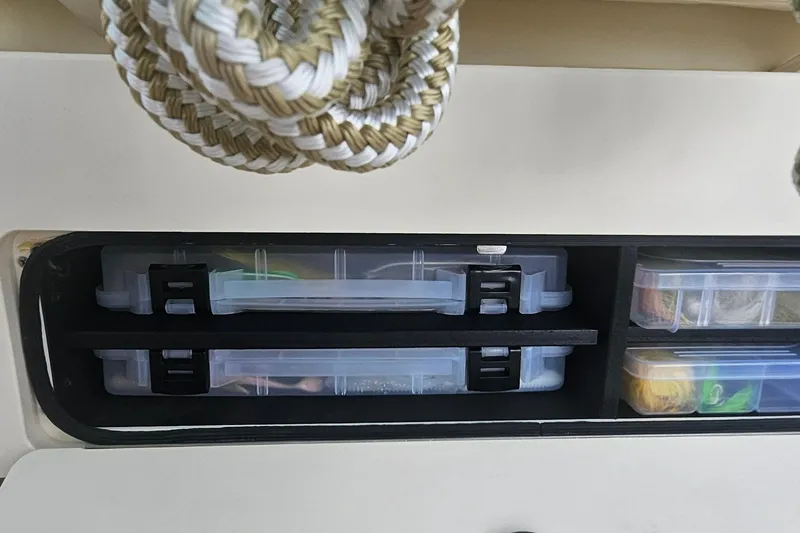 Slide: The Image of Storage compartments on a 2017 Grady-White Fisherman 257 boat, holding tackle boxes. - 43