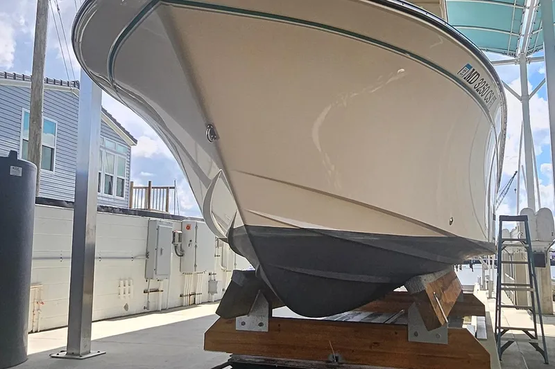 Slide: The Image of 2017 Grady-White Fisherman 257 boat on a dock, viewed from the front. - 6